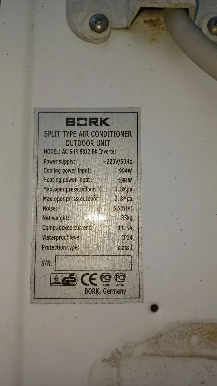 close-up of a split type air conditioner outdoor unit nameplate showing model, power supply and cooling and heating power data
